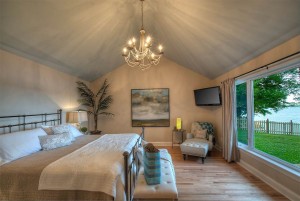 Enjoy the lake view from the main floor master bedroom with king bed.