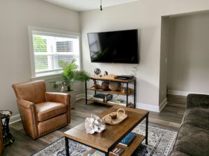Another photo of living room with 65” television