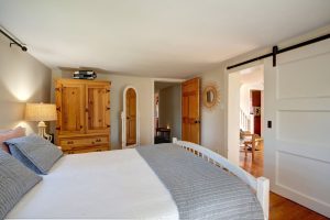 Main level primary bedroom with queen bed